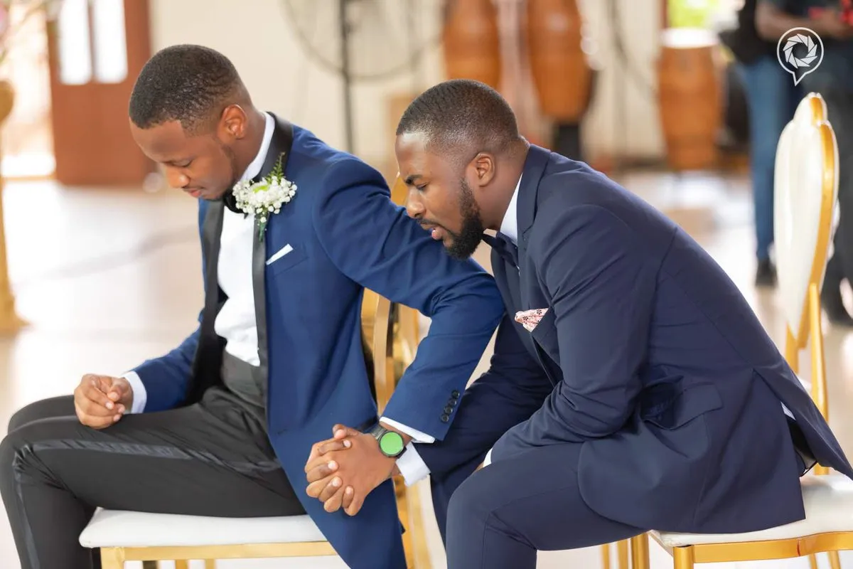 This photo of a best man praying with the groom to calm his nerve is the definition of friendship goals